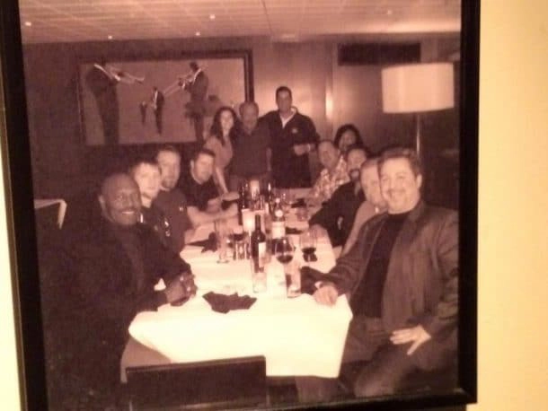 A photograph of a group of people from the Arnold Classic at a table having dinner