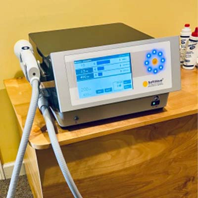 A SoftWave therapy machine on a shelf in the office
